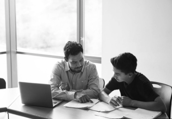 Tutor and student working together at a laptop