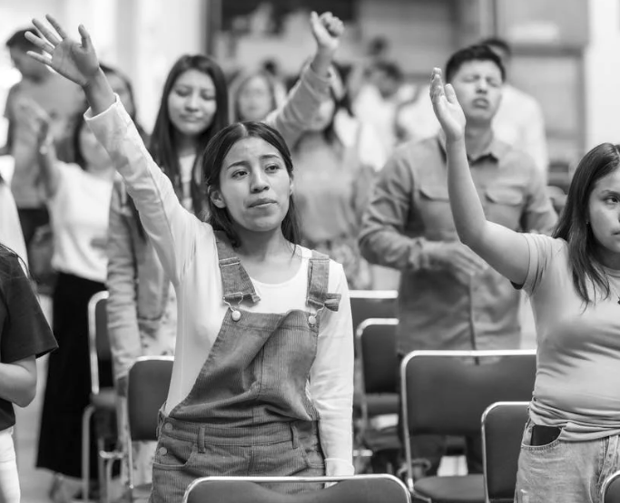 Students raising hands in a classroom